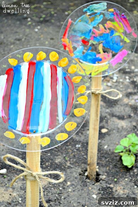 Kids painting plastic plates to create decorative garden flowers on wooden stakes.