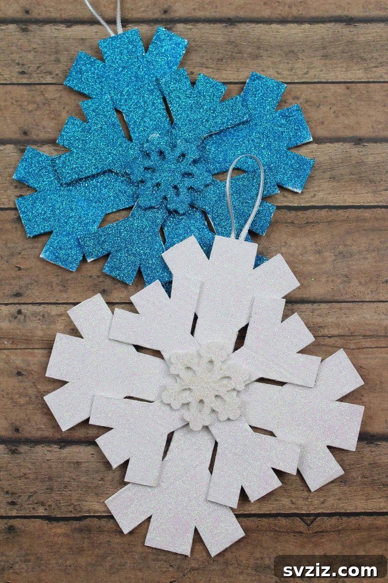 Glittery paper snowflakes hanging as winter decorations.