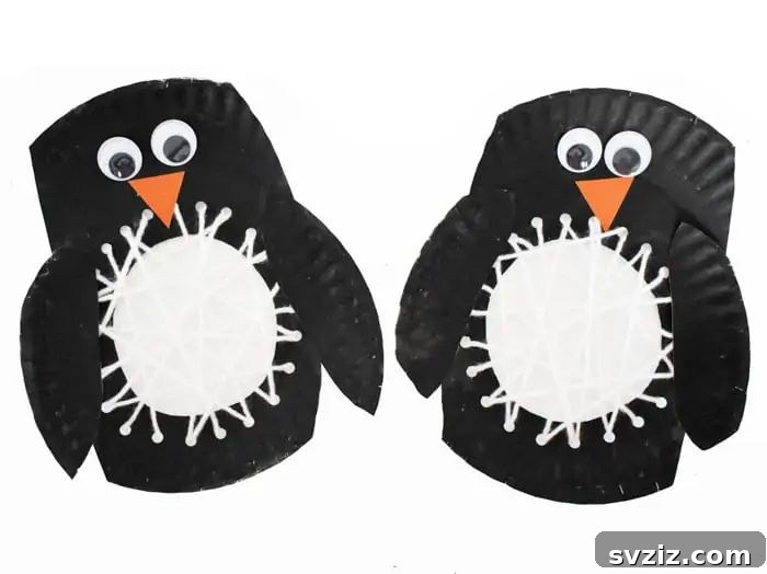 Paper plate penguin craft with yarn details.