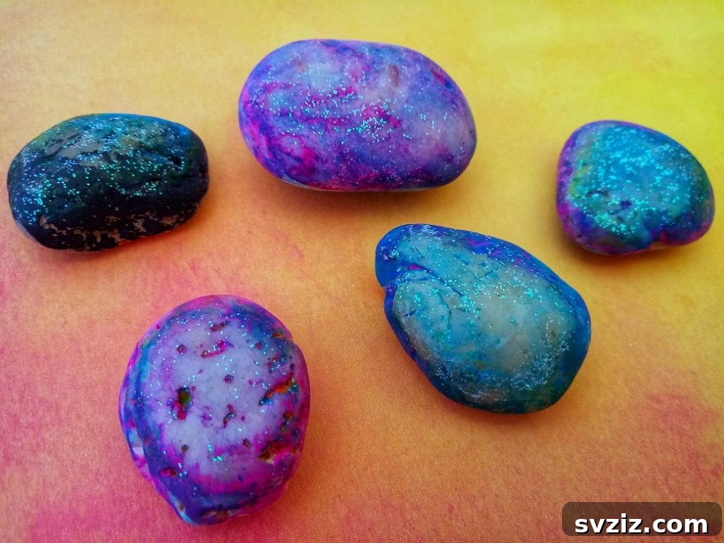 Tiny Treasures: 41 Adorable Rock Painting Ideas 16 Mesmerizing Glittery Galaxy Rocks, capturing cosmic beauty.
