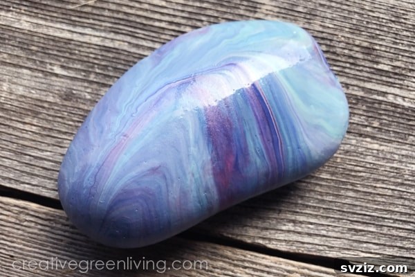 Tiny Treasures: 41 Adorable Rock Painting Ideas 19 Elegant Marbled Rocks with a glossy, unique finish.