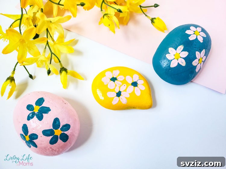 Tiny Treasures: 41 Adorable Rock Painting Ideas 20 Elegant Flower Painted Rocks with subtle, realistic floral designs.