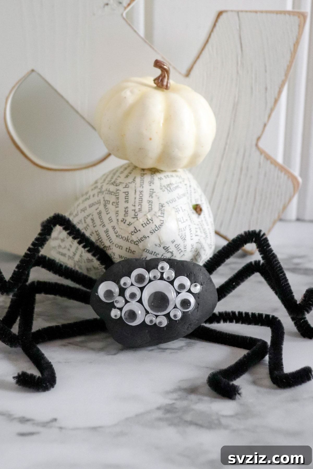 Tiny Treasures: 41 Adorable Rock Painting Ideas 26 Creepy-crawly Painted Spider Rock with googly eyes and pipe cleaner legs.