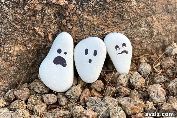 Tiny Treasures: 41 Adorable Rock Painting Ideas 33 Spooky and fun Halloween Ghost Rock Craft for easy decor.