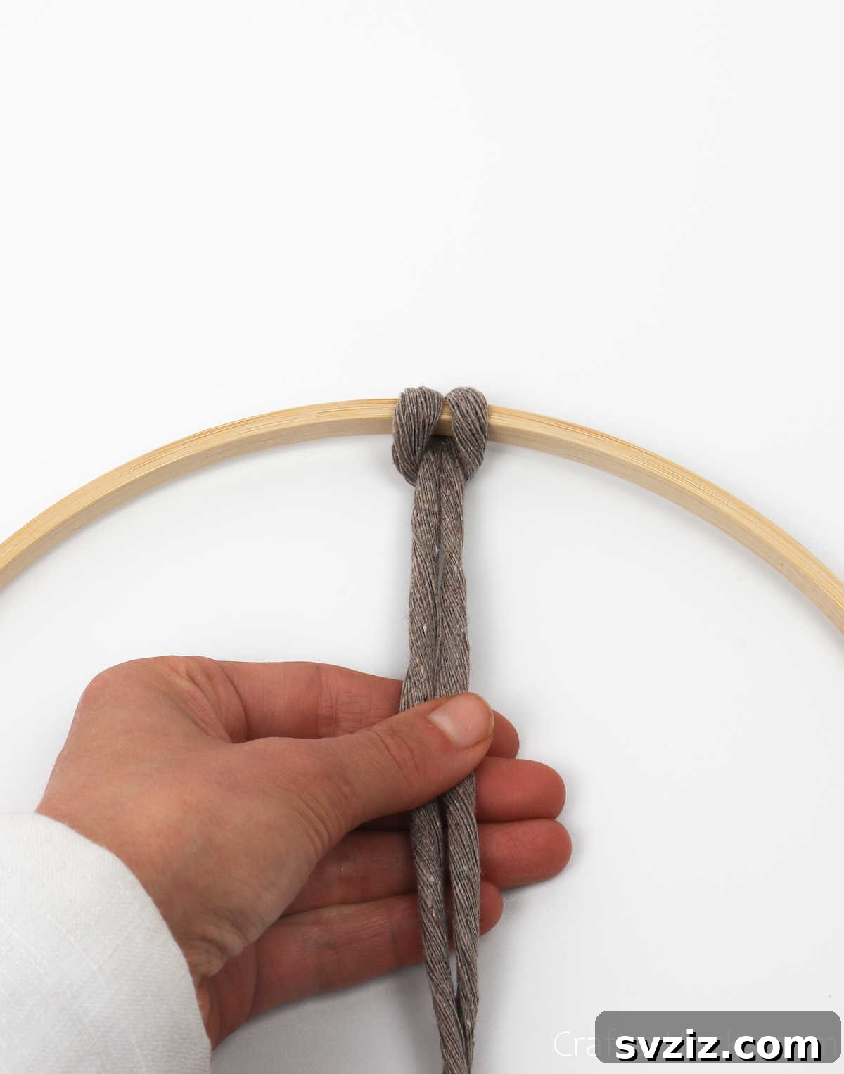 A perfectly tightened knothead on the hoop, demonstrating the secure attachment of the cord.
