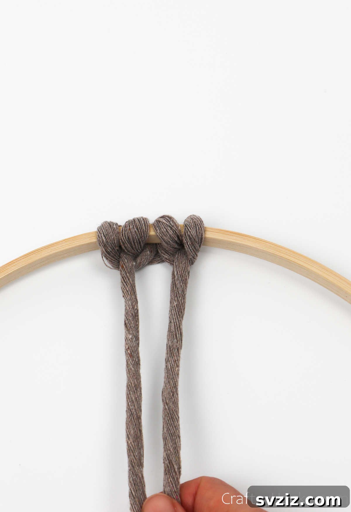 A completed set of three knotheads, showing two symmetrical loops with a central knot on the hoop.