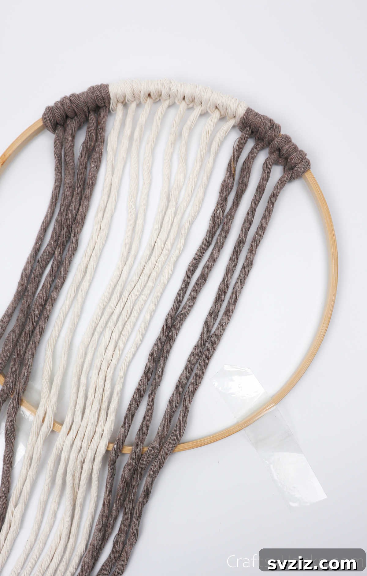 The completed pattern on one side of the hoop, showing 2 cappuccino, 4 cream, and 2 cappuccino cord sets.