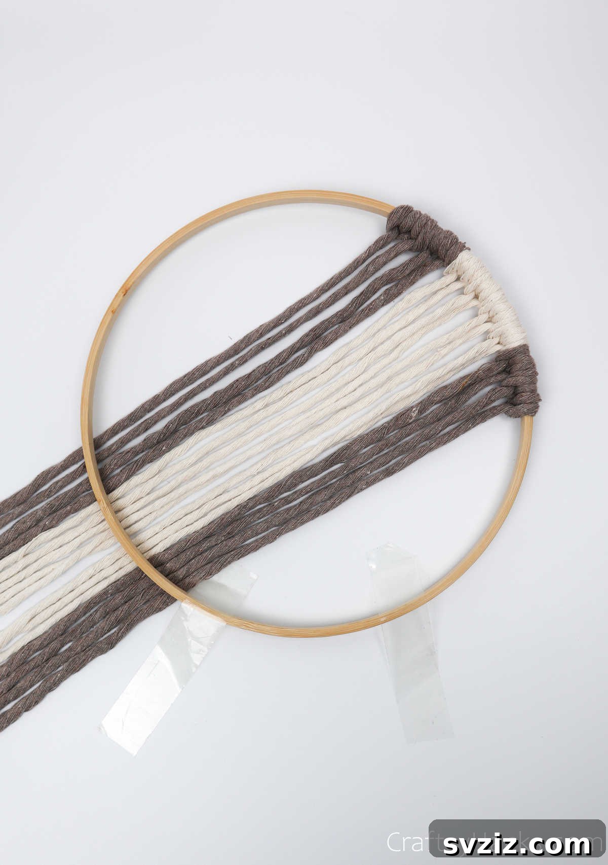 The hoop with one side of the cord pattern completed and all strings neatly pulled under.