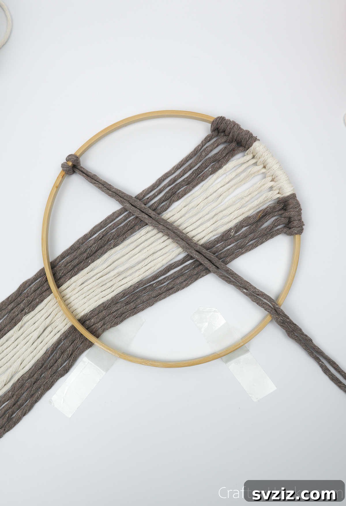 Adding cappuccino-colored yarn to the left side of the hoop, mirroring the pattern from the right.