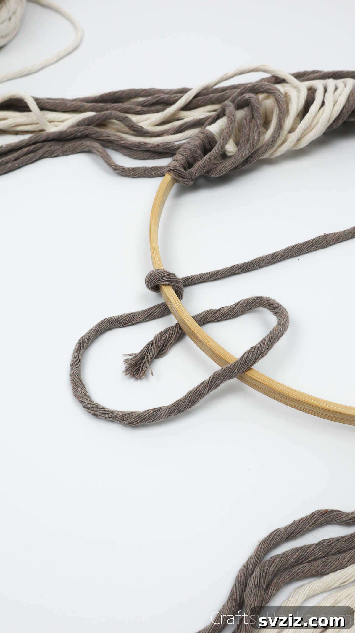 The second loop of yarn being made to complete the full knot for the diagonal design.