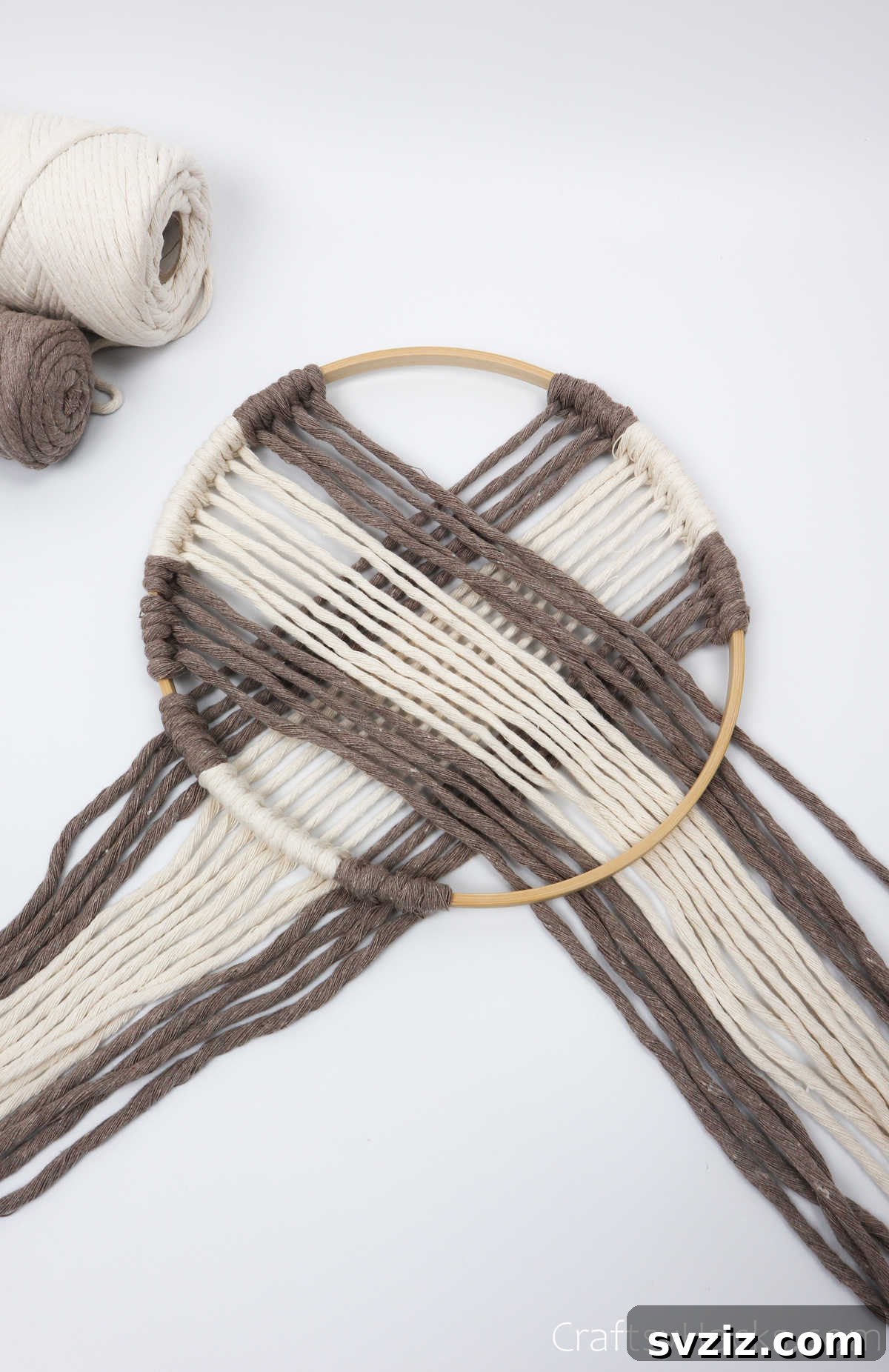 All the cords from one side are neatly laid within the hoop, ready for diagonal knotting on the opposite side.
