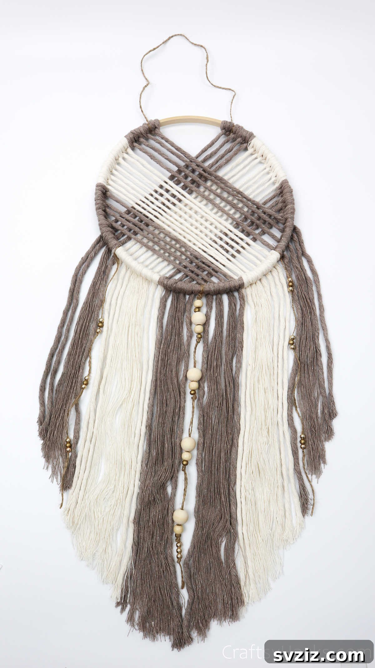 The dreamcatcher lying flat after the cords have been combed out, showing the softened texture.