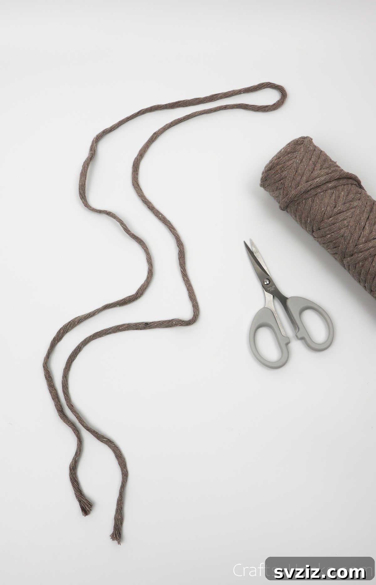 A single sixty-inch piece of cotton cord laid out, ready for cutting into multiple strands.