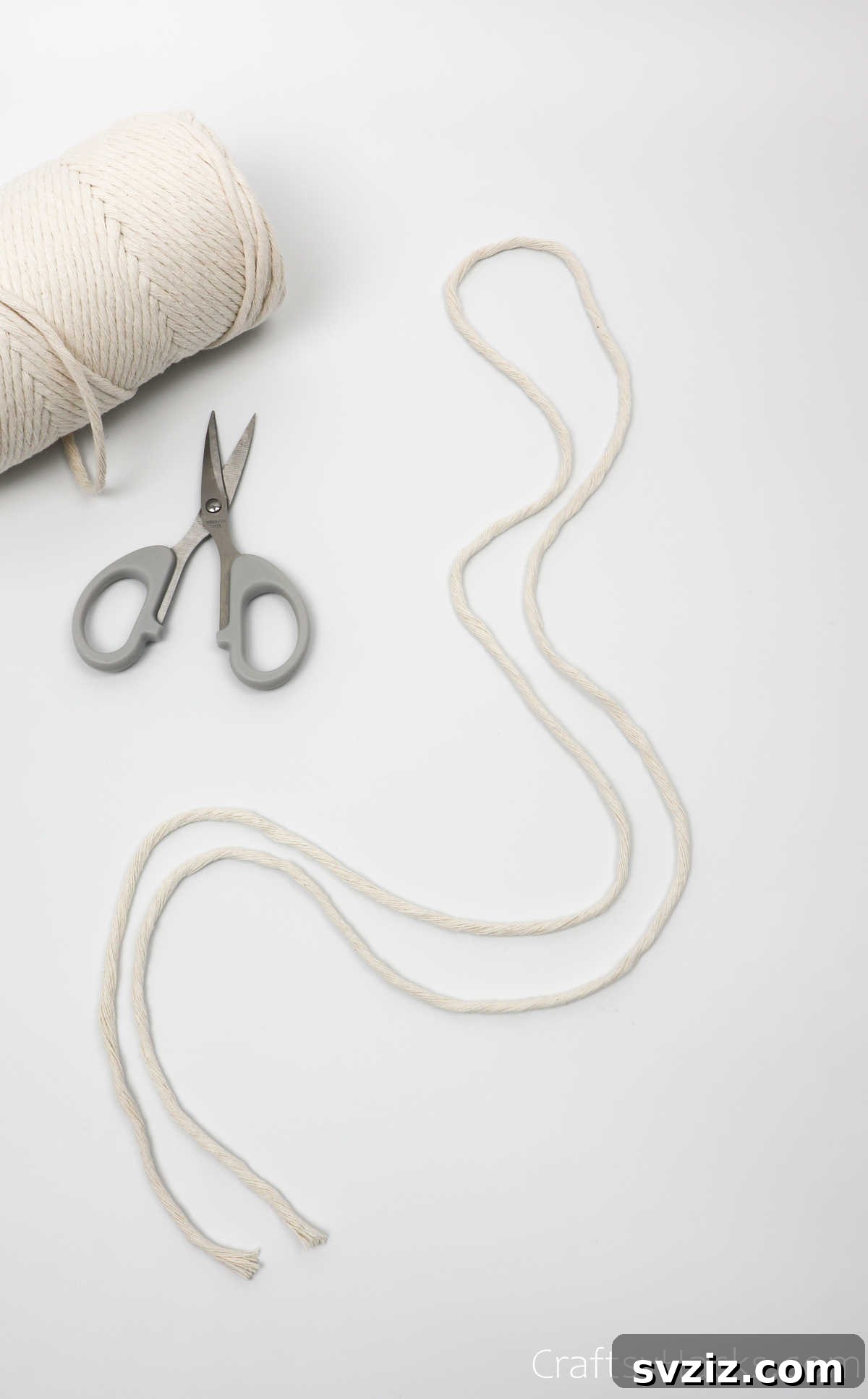 A single length of cream-colored yarn, cut and prepared for the dreamcatcher.