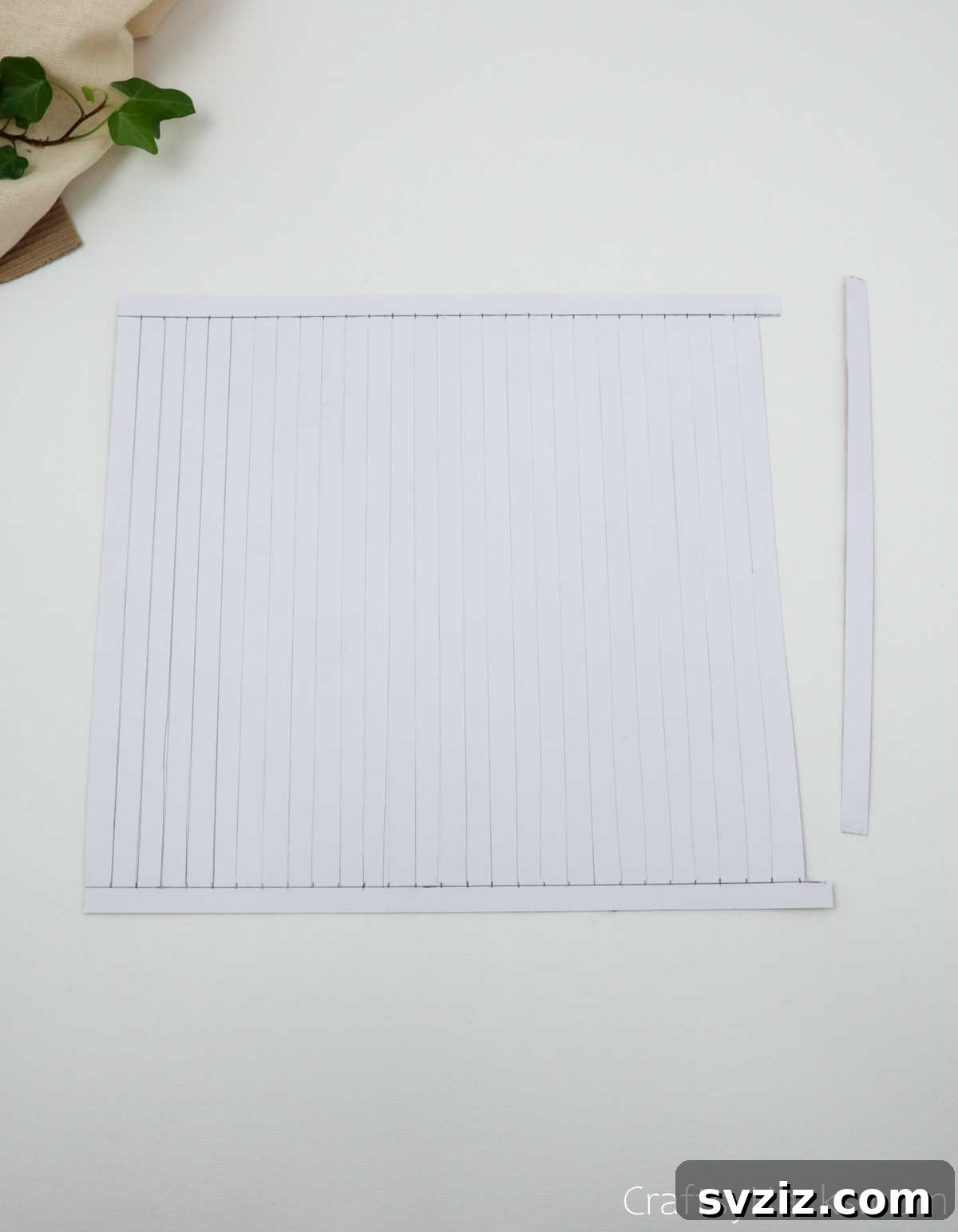 Craft Your Own Stunning Paper Lanterns 11 A single strip of craft paper is cut and removed from one end to create a clean gap, preparing for assembly.