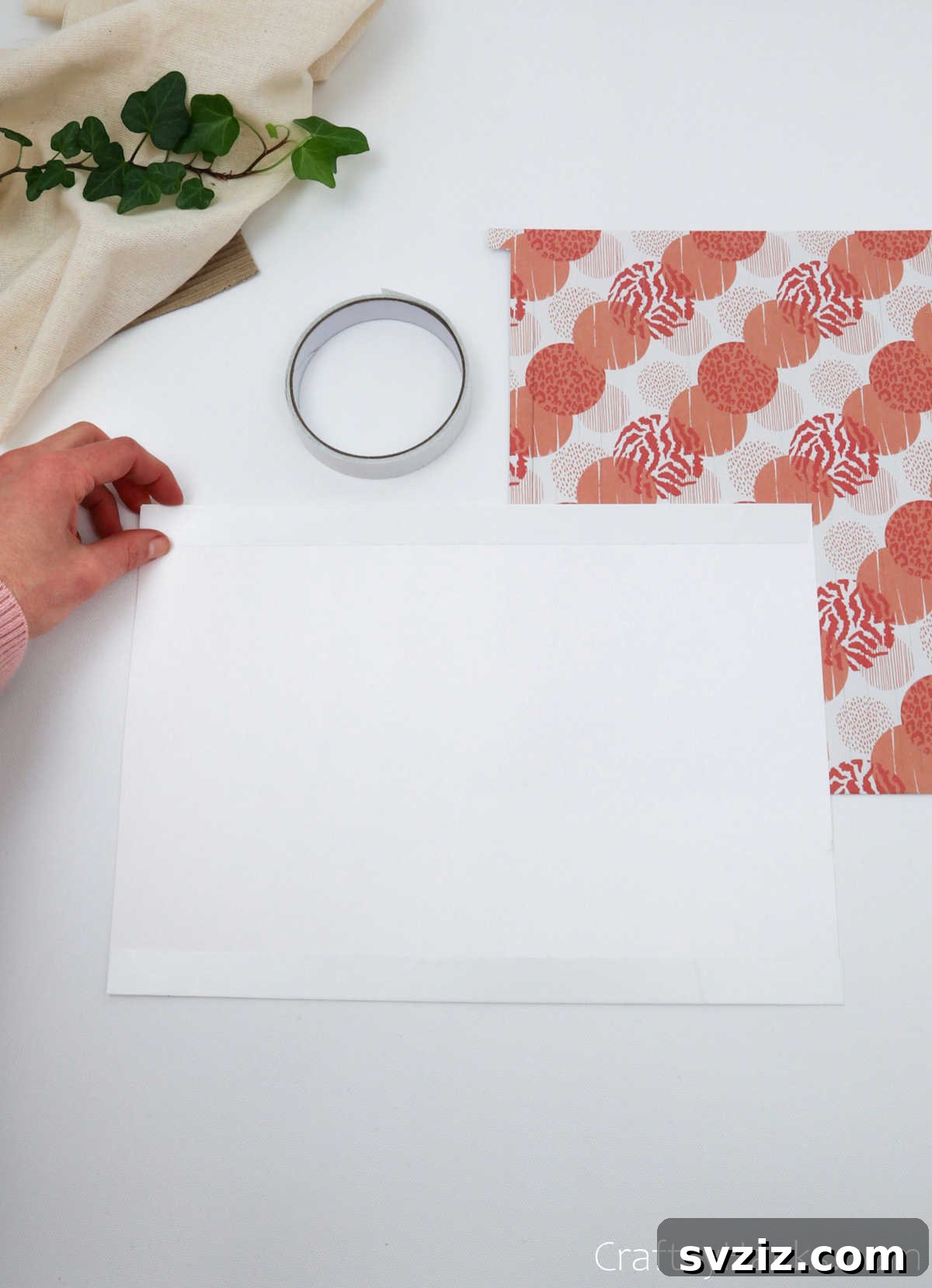 Craft Your Own Stunning Paper Lanterns 12 A sheet of white paper with two long strips of double-sided tape applied along its top and bottom edges.