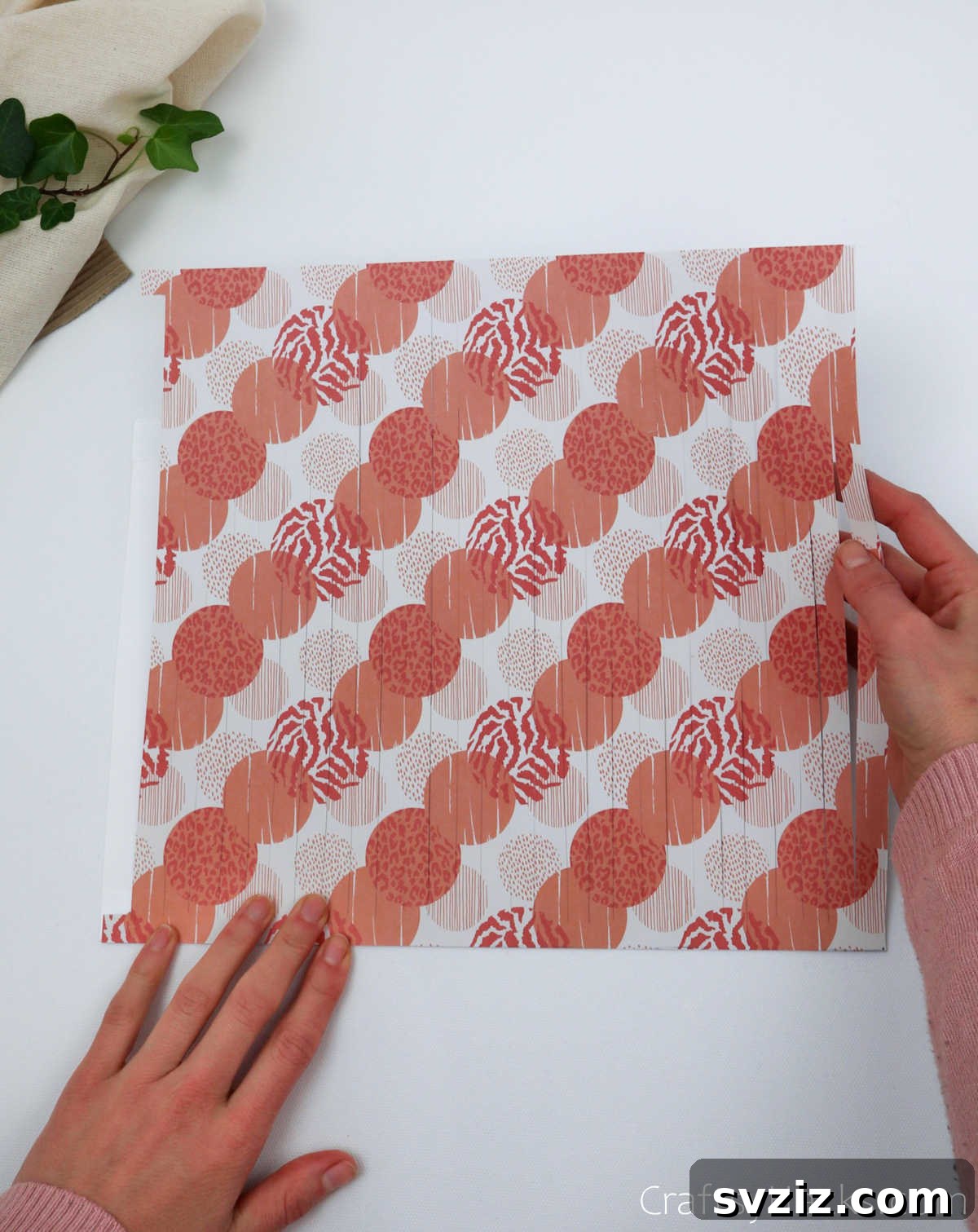 Craft Your Own Stunning Paper Lanterns 13 The cut craft paper is carefully attached to the smaller white paper lining with double-sided tape at the top and bottom.