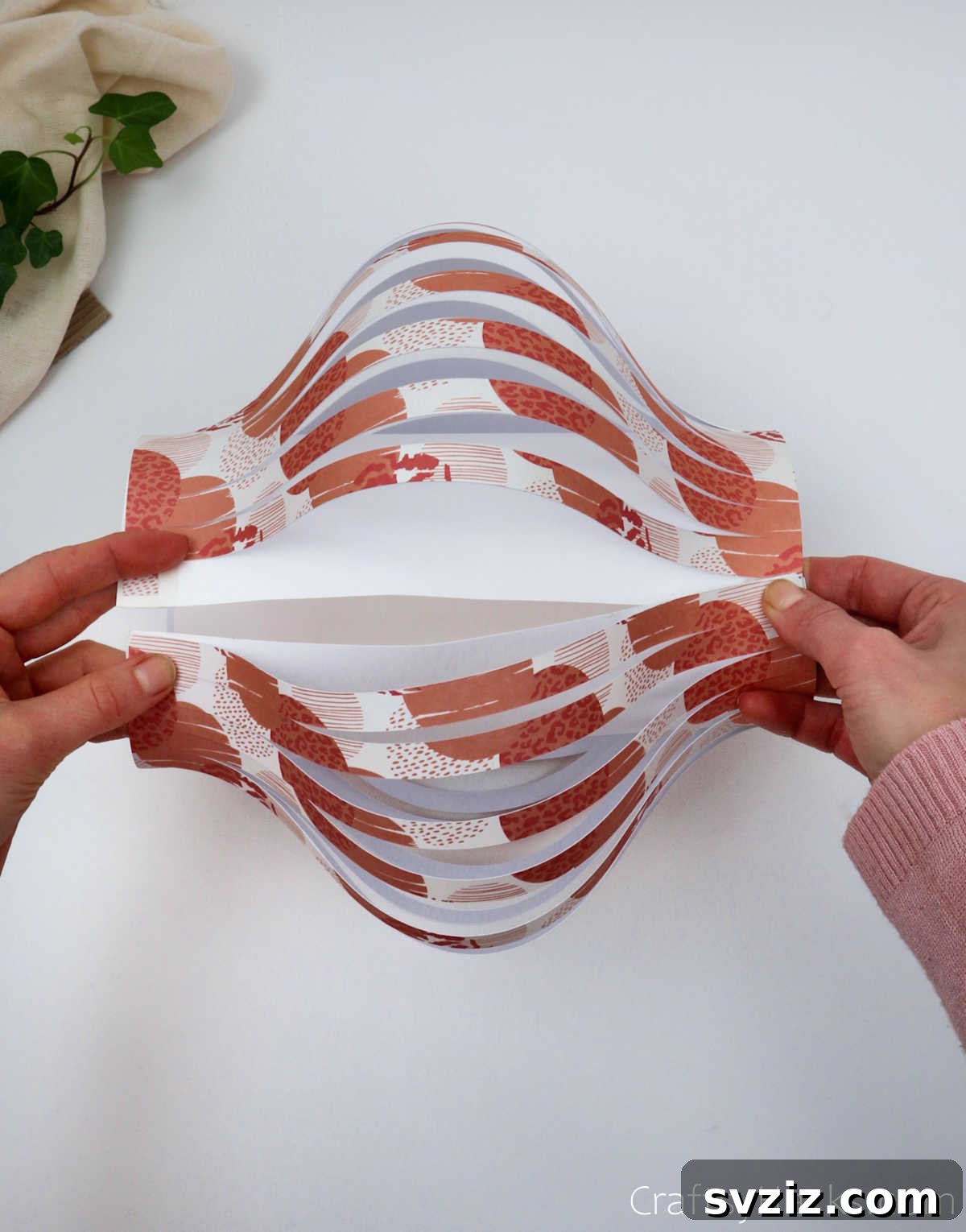 Craft Your Own Stunning Paper Lanterns 18 The cylindrical lantern body is complete, showcasing the billowing effect of the cut paper strips.
