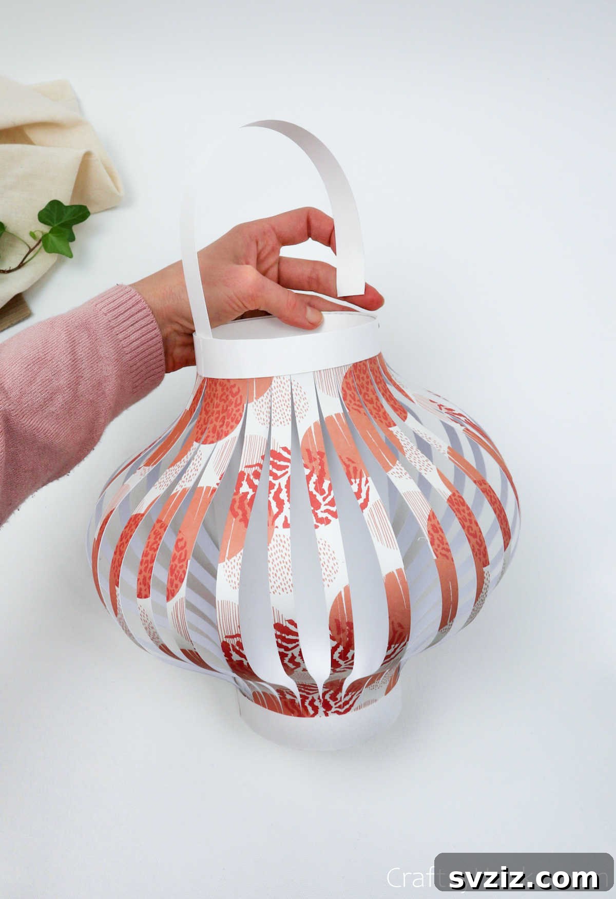 Craft Your Own Stunning Paper Lanterns 22 The final white paper strip is folded into a handle and attached to the top inside rim of the paper lantern.