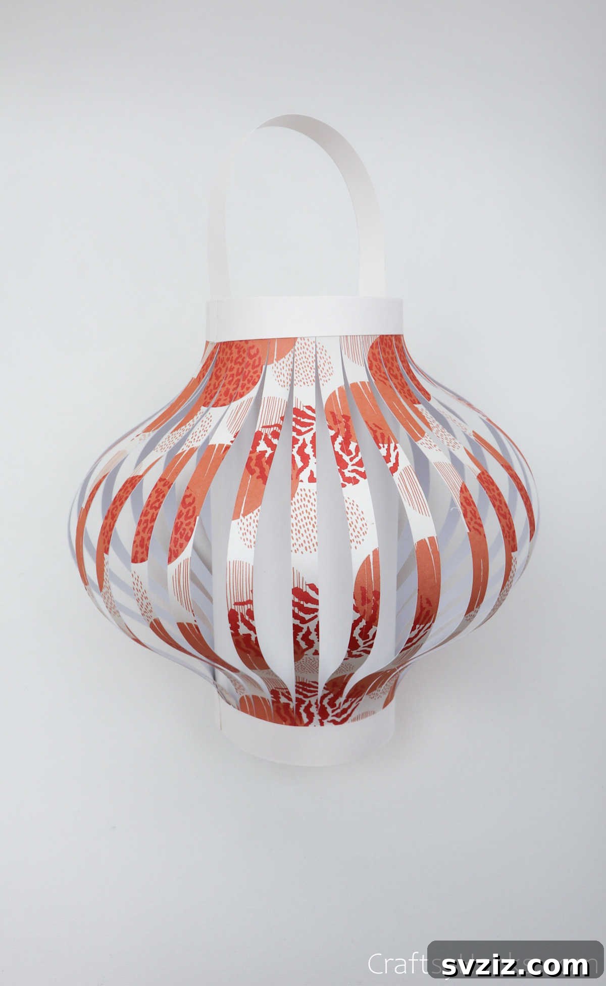 Craft Your Own Stunning Paper Lanterns 23 A newly finished paper lantern with its handle attached, showcasing the completed basic structure.