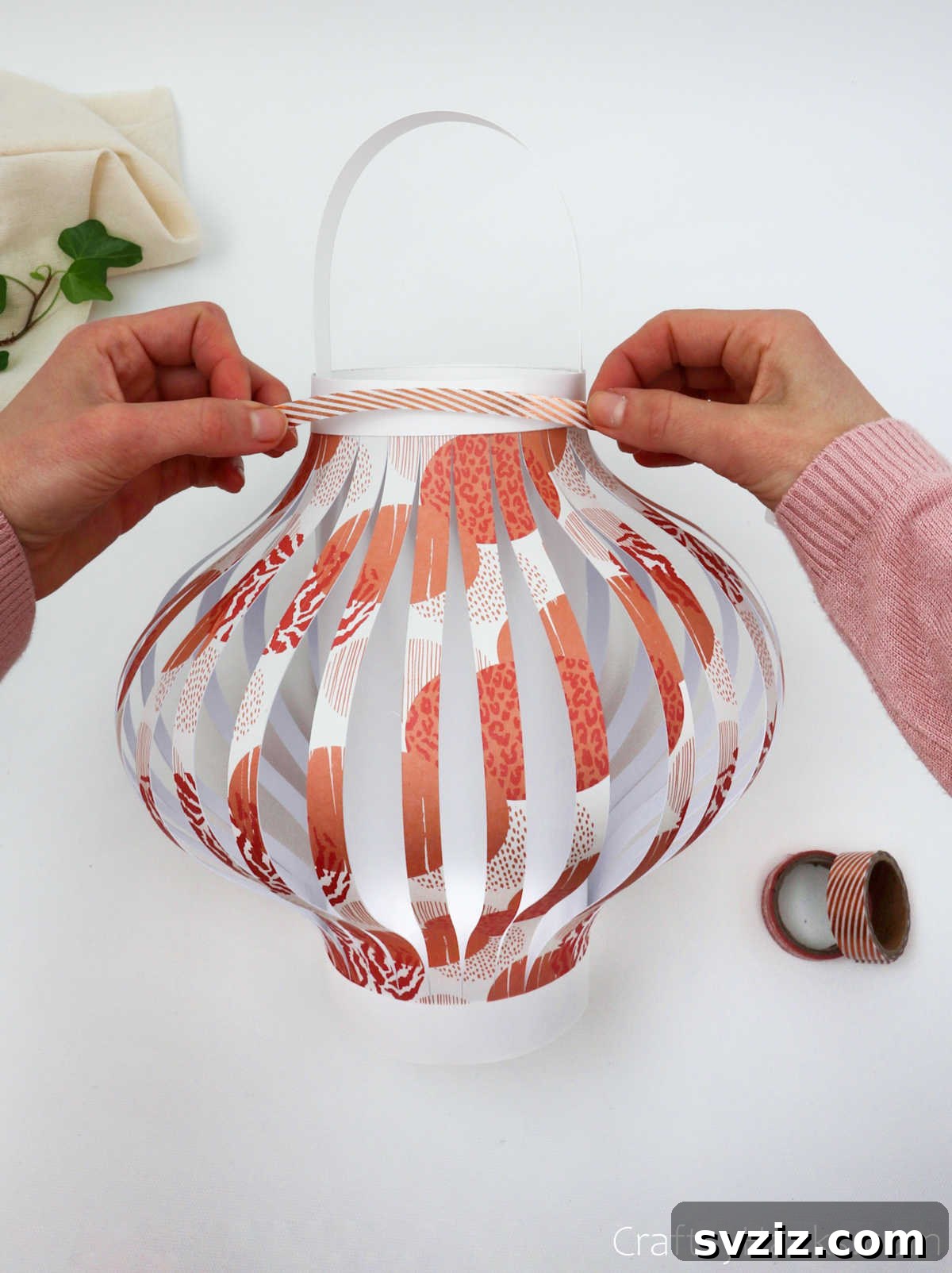Craft Your Own Stunning Paper Lanterns 24 Decorative washi tape being applied to the finished paper lantern, adding a unique touch of personalization.