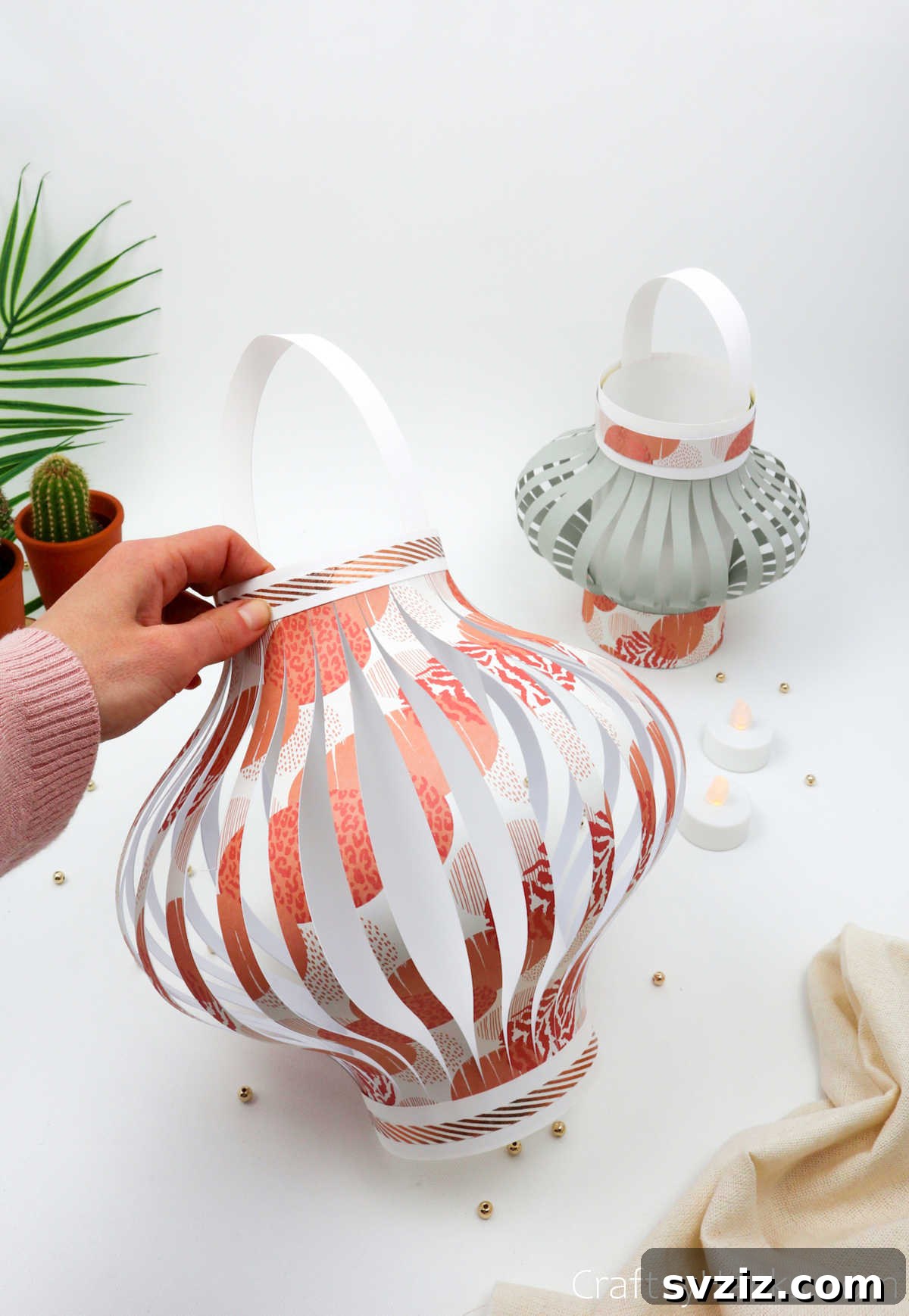 Craft Your Own Stunning Paper Lanterns 28 A person proudly holds up a finished, illuminated paper lantern, showcasing the joy of DIY crafting and beautiful home decor.