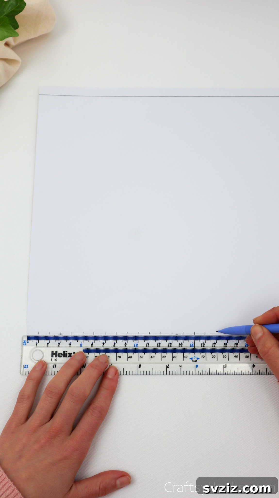 Craft Your Own Stunning Paper Lanterns 7 A ruler is used to precisely mark centimeter intervals along the previously drawn horizontal lines on the craft paper.
