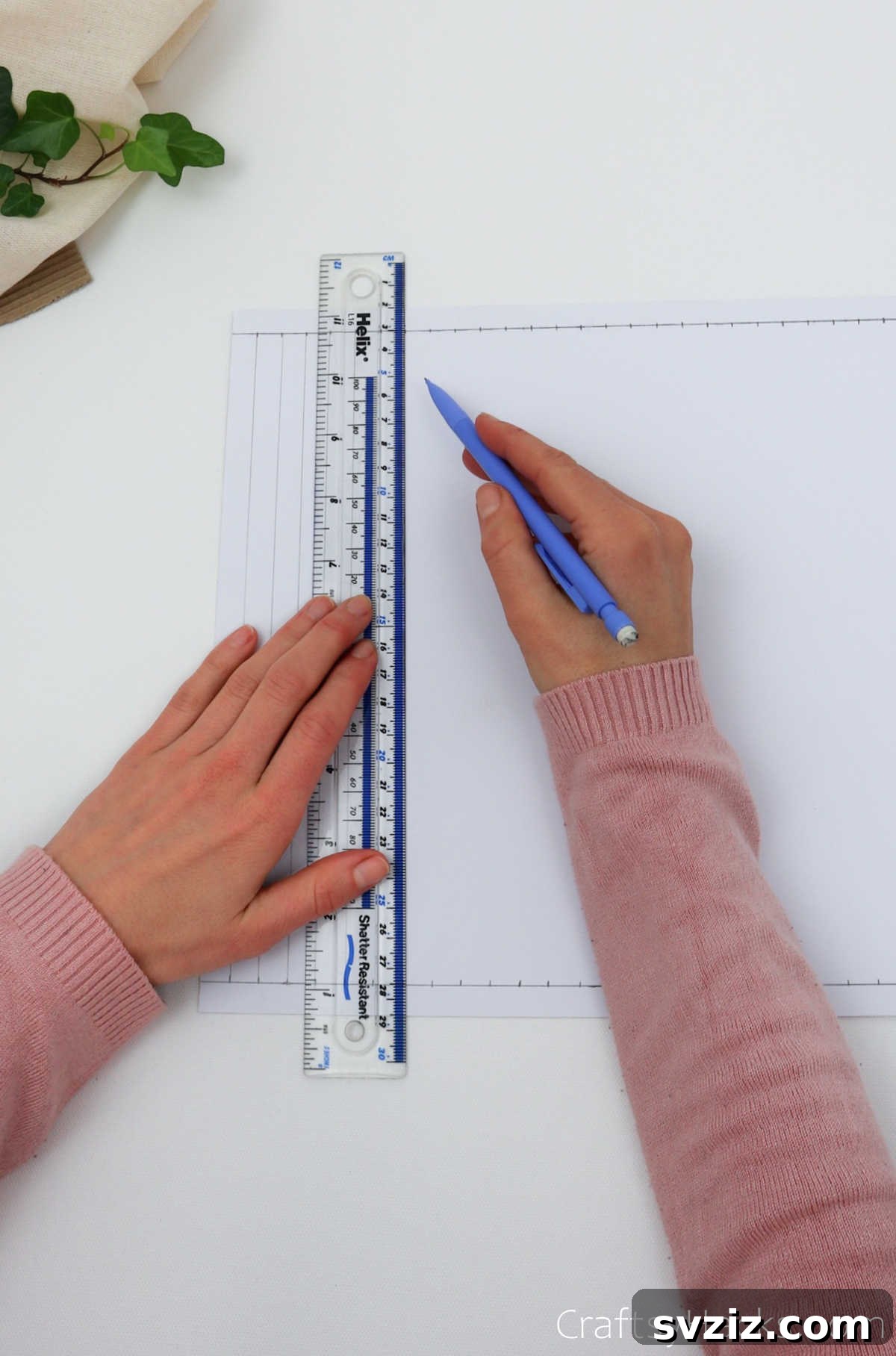 Craft Your Own Stunning Paper Lanterns 8 A ruler and pencil are used to draw vertical lines, connecting the marked points from the top to the bottom guide lines.