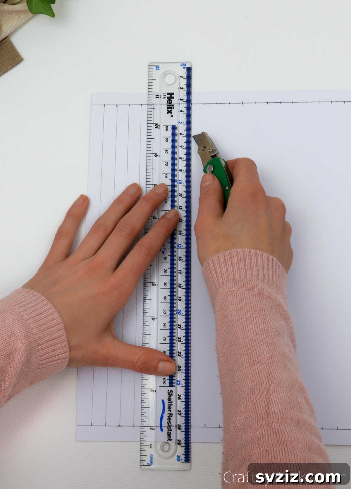 Craft Your Own Stunning Paper Lanterns 9 A craft knife guided by a ruler makes precise vertical cuts between the horizontal guide lines on the craft paper.