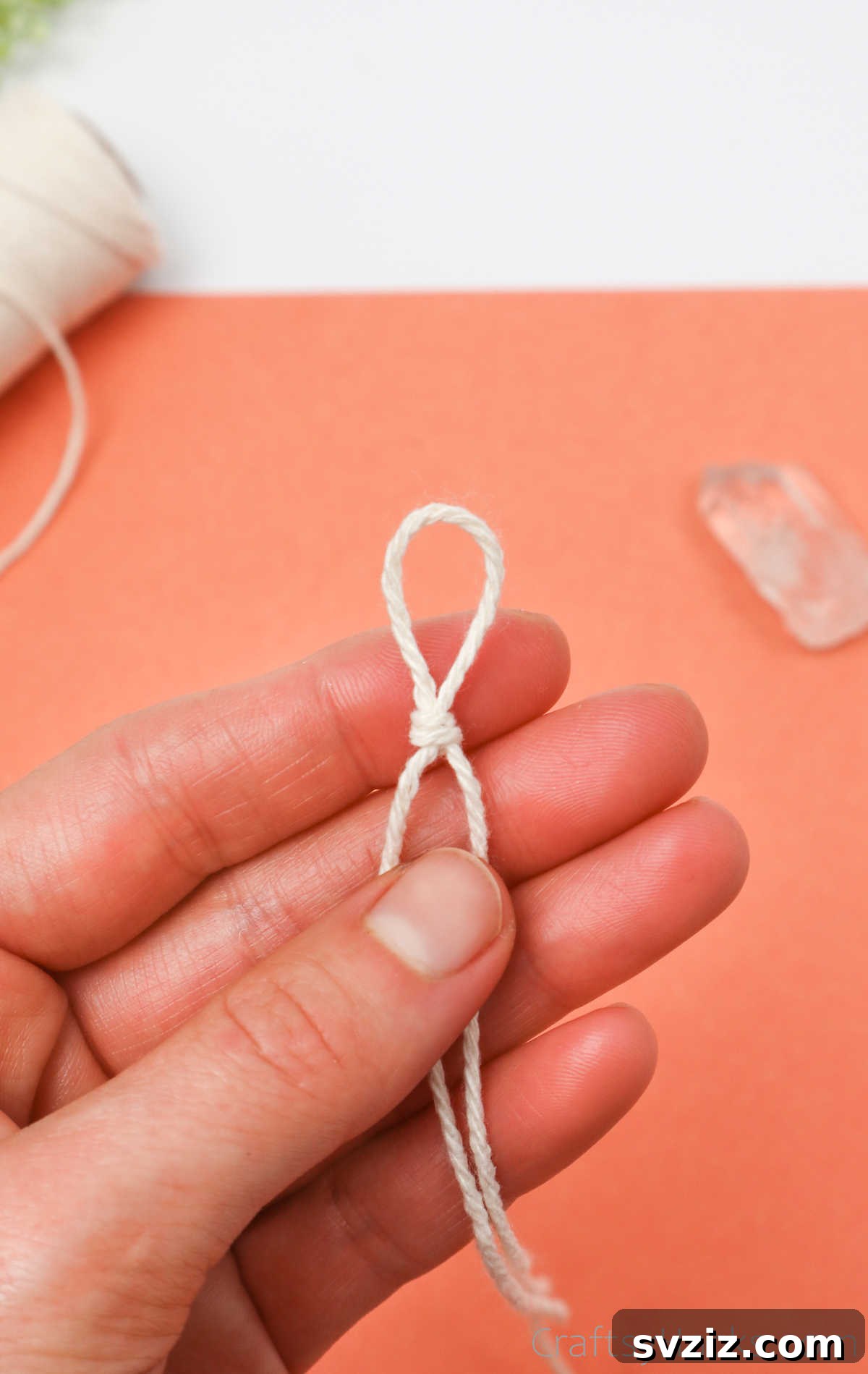 Simple Stone Necklace DIY Guide 14 A clear image of the first overhand knot made in the string loop, ready for the crystal