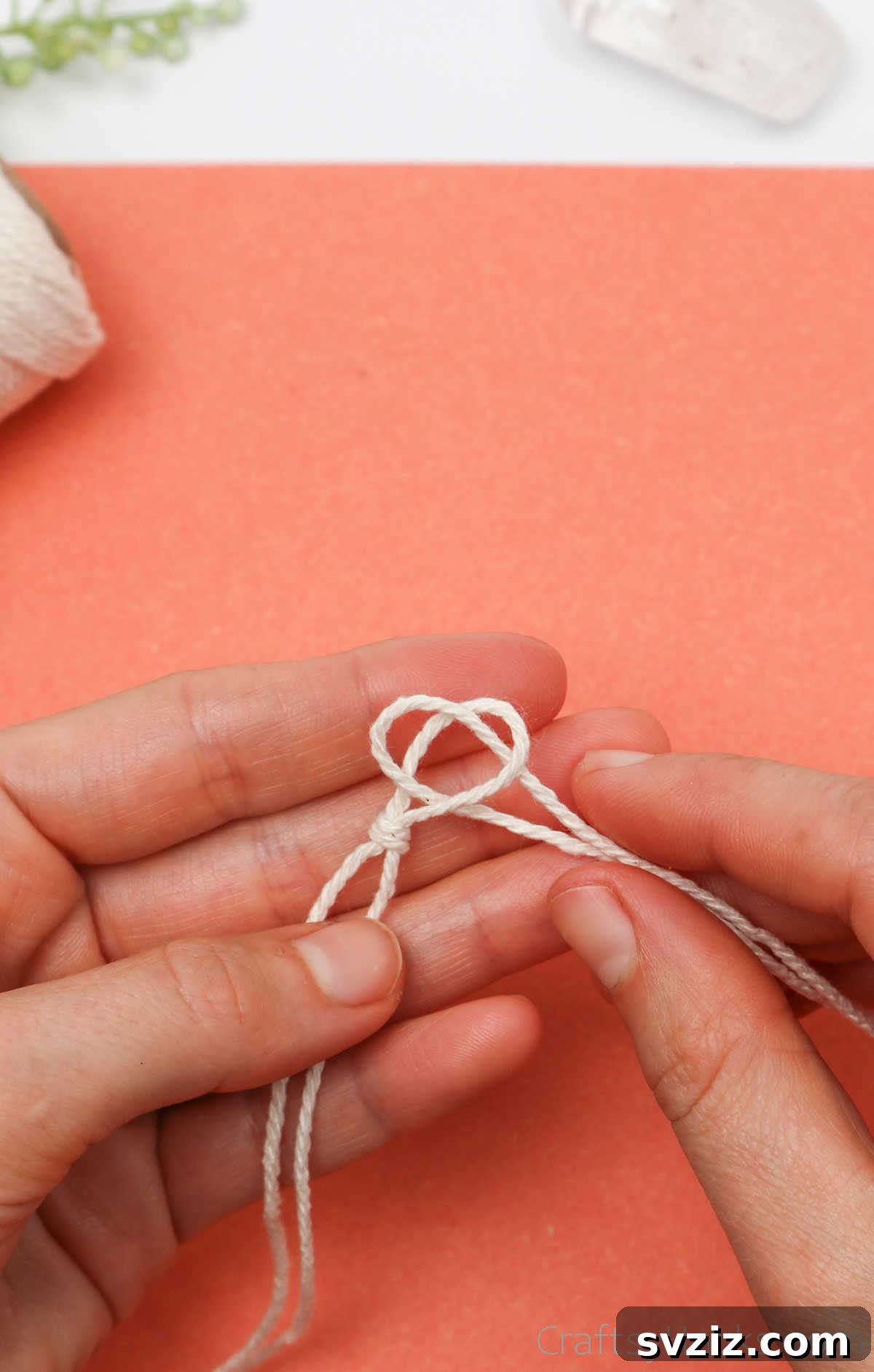 Simple Stone Necklace DIY Guide 16 Close-up of the second cord's loop emerging through the first knot's loop, initiating the connection