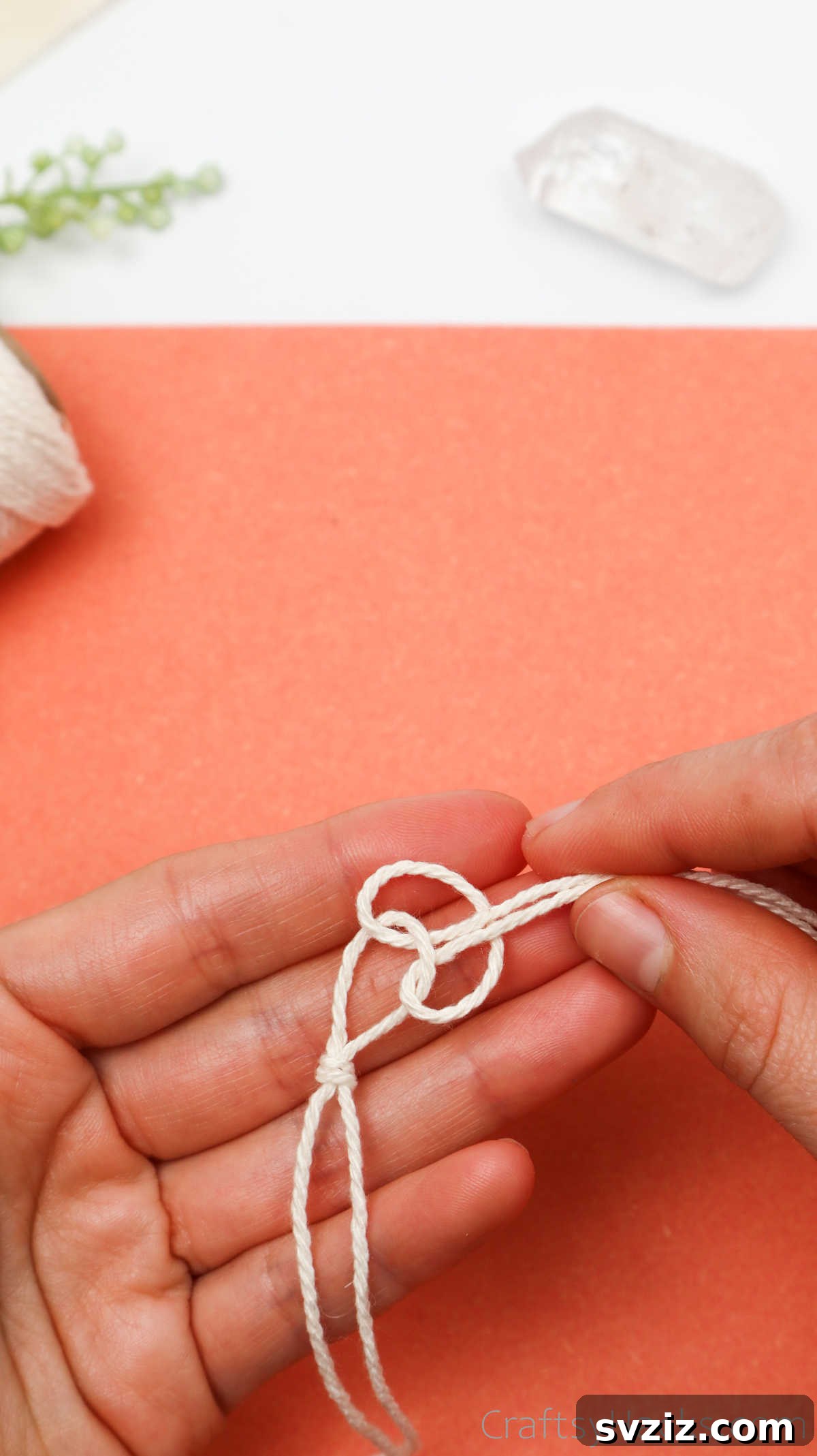 Simple Stone Necklace DIY Guide 18 Demonstration of pulling the loose ends through, showing the knot taking shape around the first loop