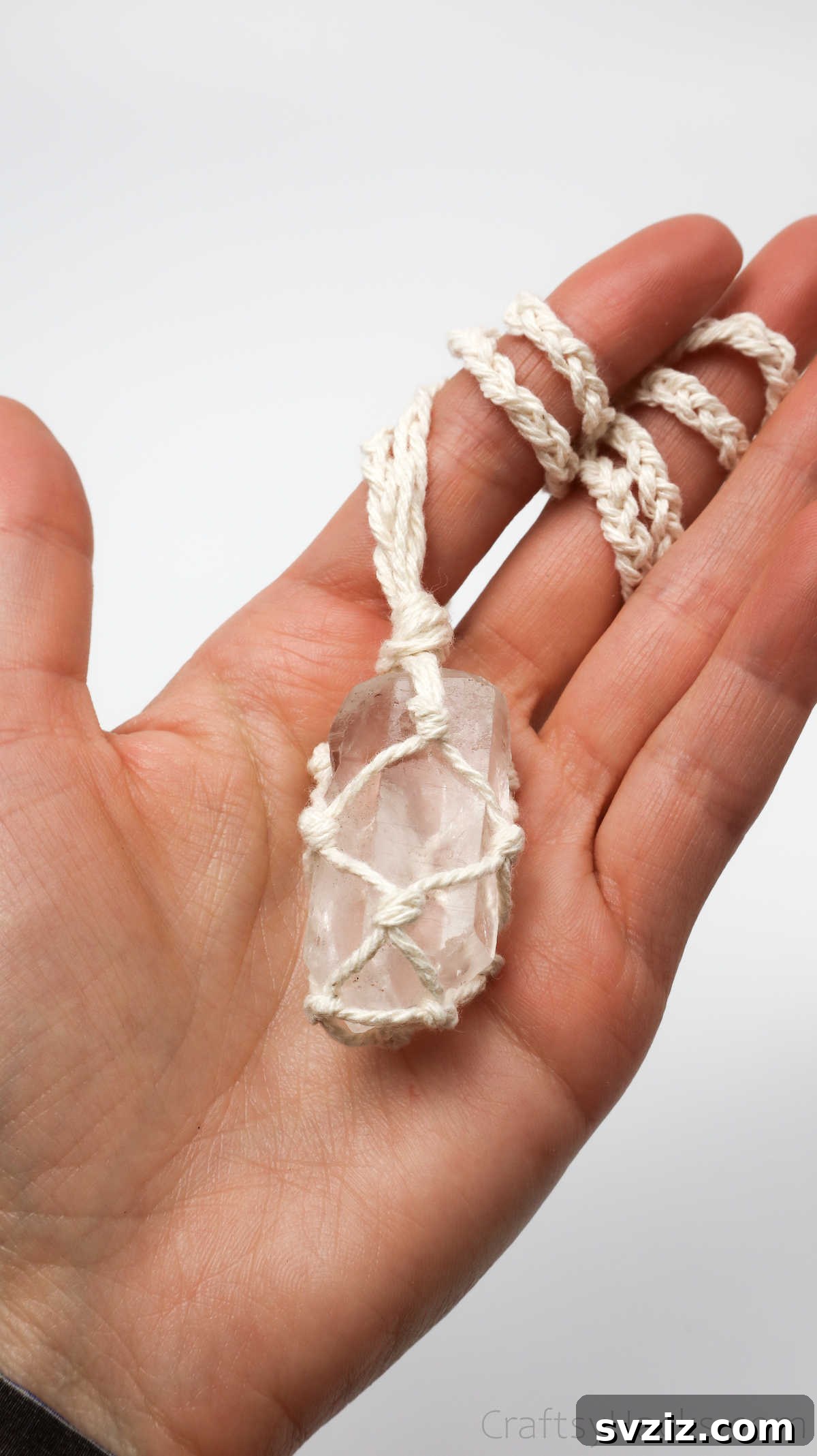 Simple Stone Necklace DIY Guide 3 Close-up of hands holding a beautifully knotted macrame necklace with a stone