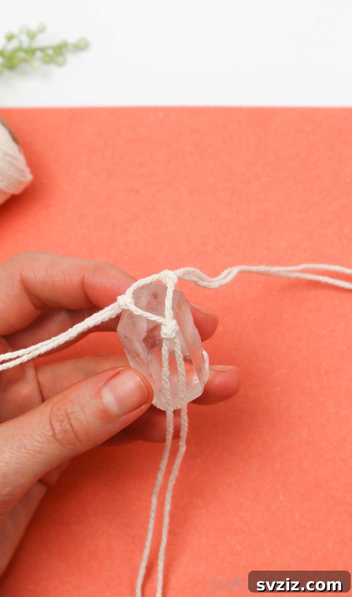 Simple Stone Necklace DIY Guide 23 A crystal being carefully placed into the macrame base, checking for a snug and secure fit