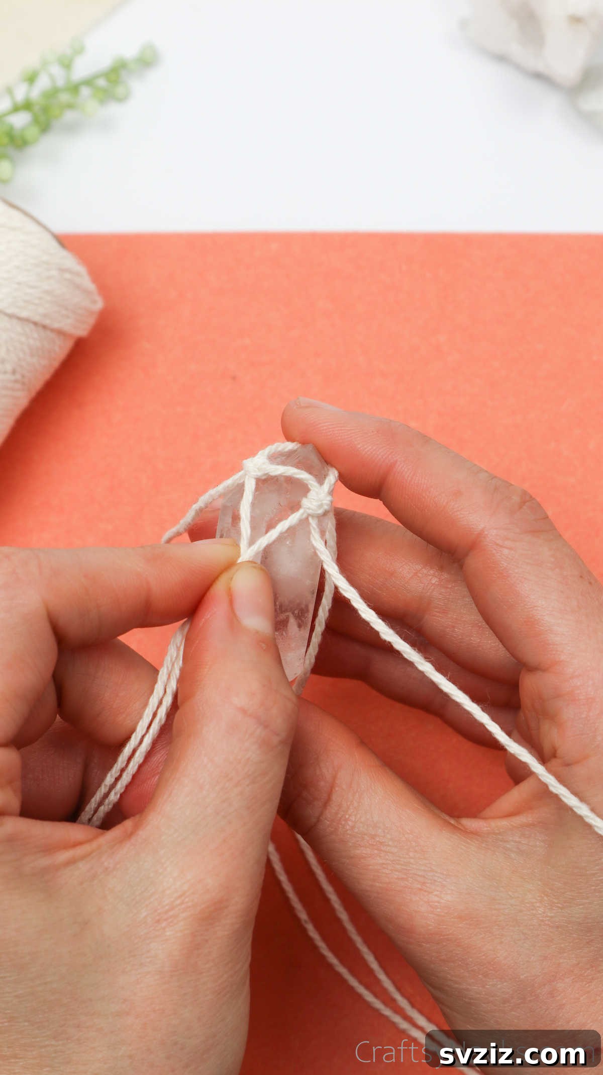 Simple Stone Necklace DIY Guide 24 Hands demonstrating how to pick two individual strands from adjacent cords to begin netting around the crystal