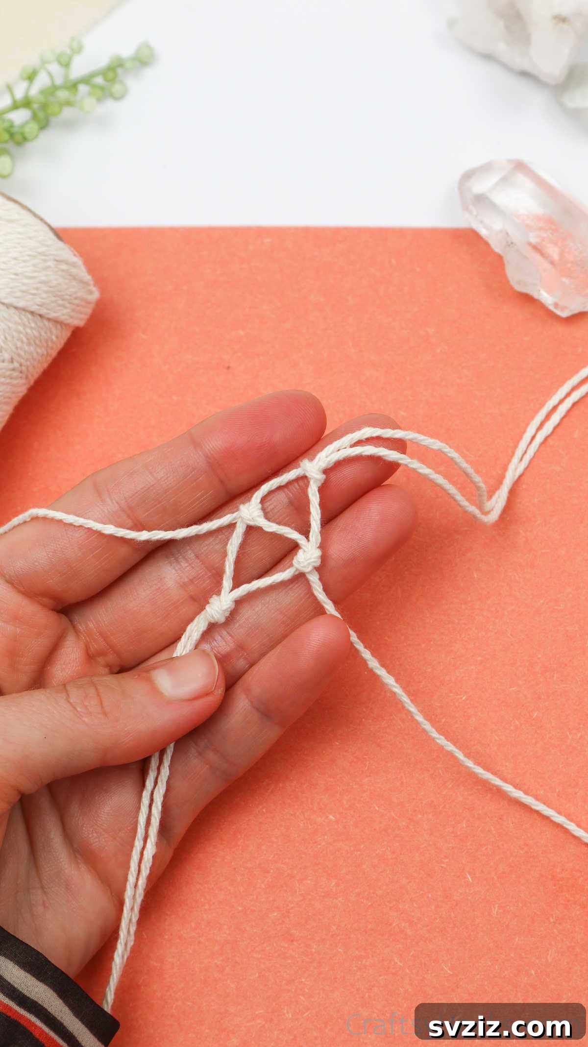 Simple Stone Necklace DIY Guide 25 A new overhand knot being tied with two strands, forming a second triangle in the macrame netting