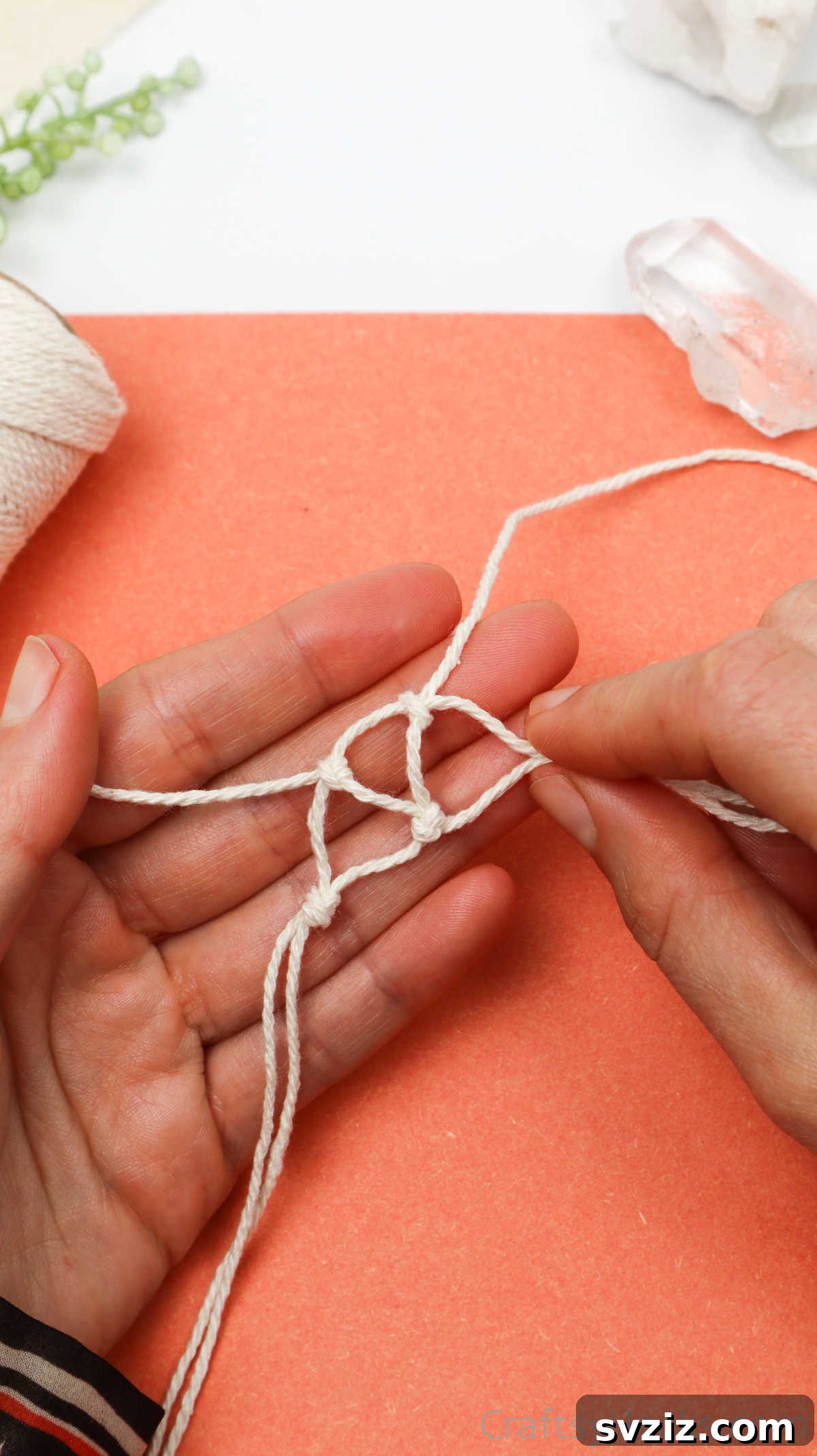 Simple Stone Necklace DIY Guide 26 Hands tying the next set of knots to form the third triangle, maintaining the macrame pattern