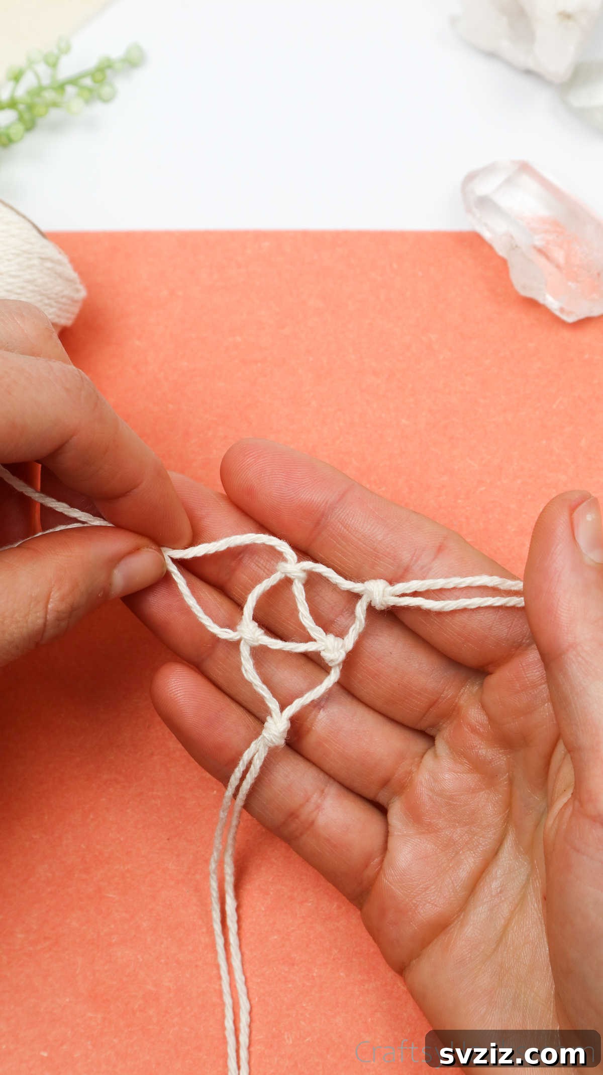 Simple Stone Necklace DIY Guide 28 The macrame netting continuing to grow around the crystal, demonstrating the upward knotting