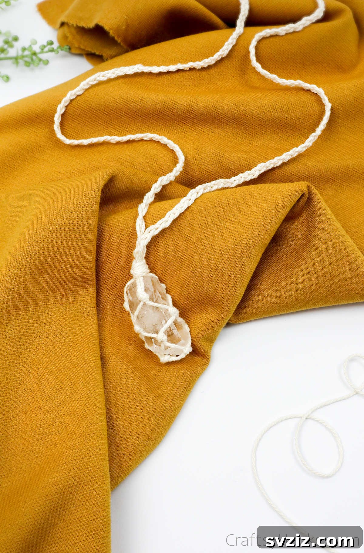 Simple Stone Necklace DIY Guide 44 A beautifully handcrafted DIY macrame necklace displayed on a piece of fabric, showcasing its appeal for gifting and selling