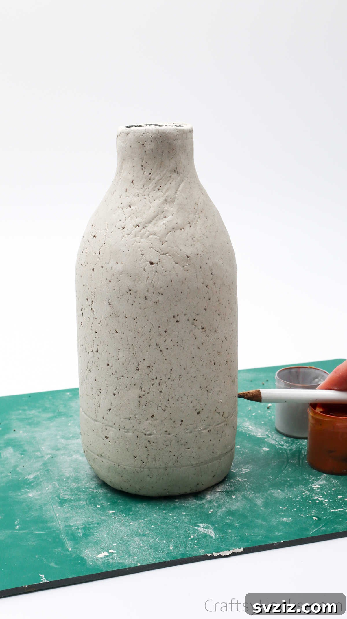 Tracing Lines with Pencil on Dried Clay Vase