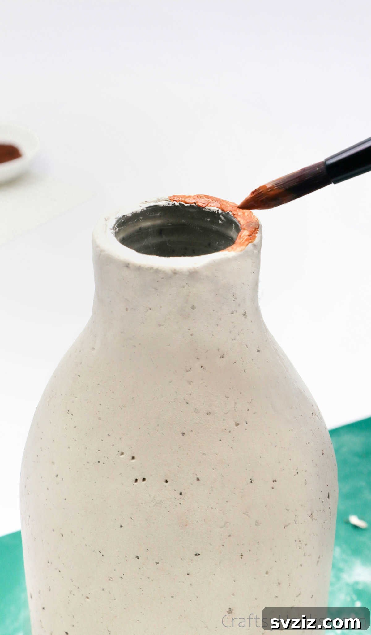 Painting the Top Rim of the Clay Bottle Vase