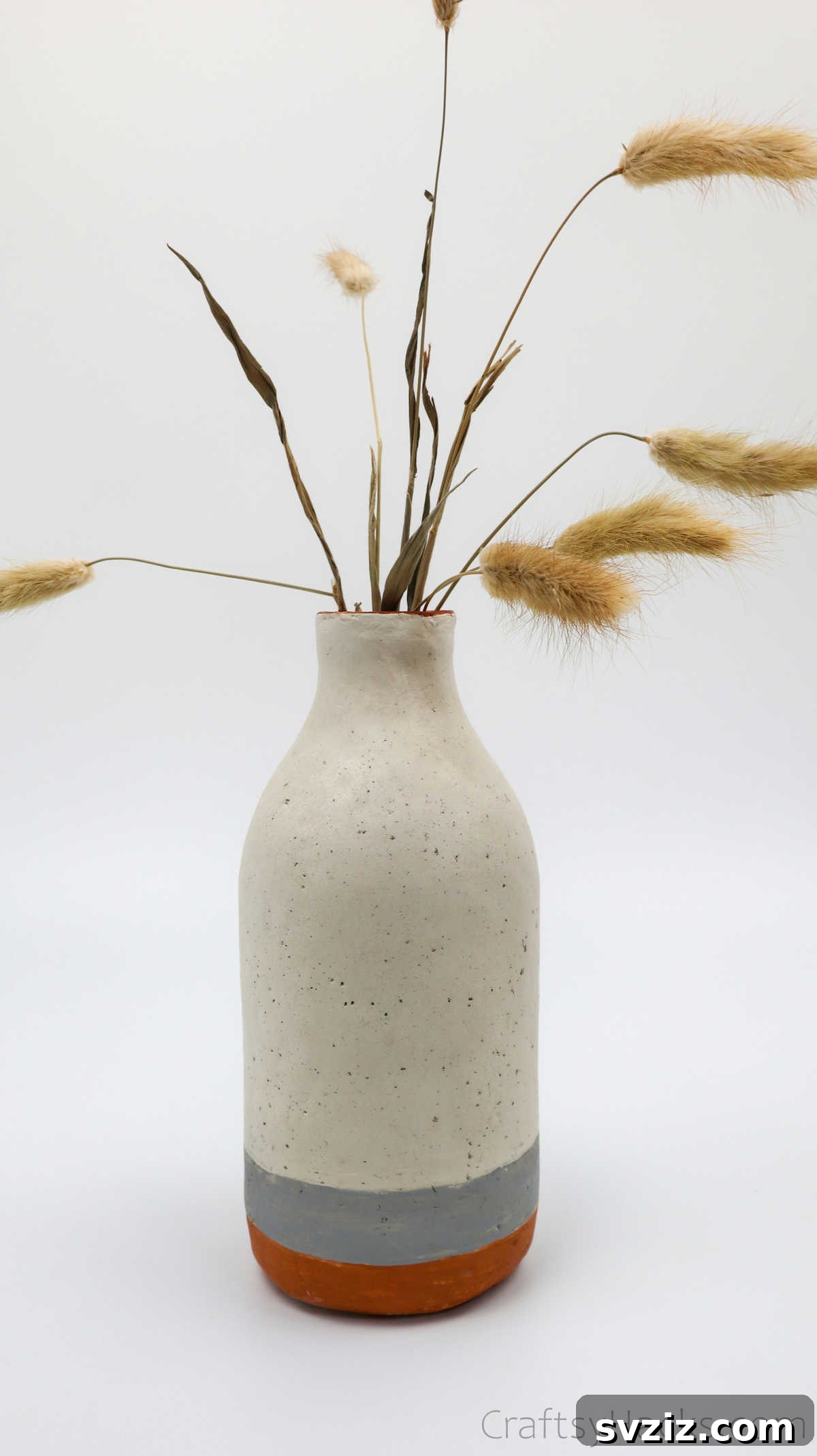 Dried Flowers Artfully Arranged in a Clay Vase