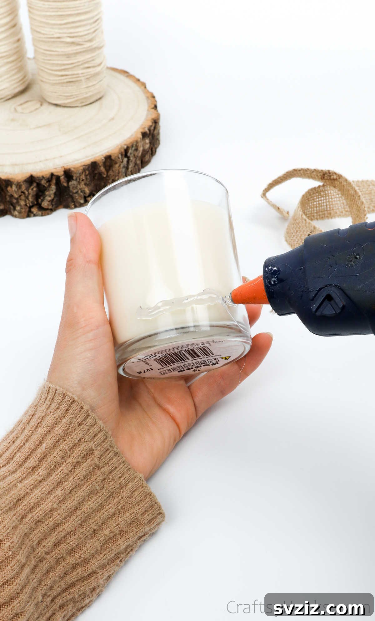Applying Glue to a Jar Candle for Decoration