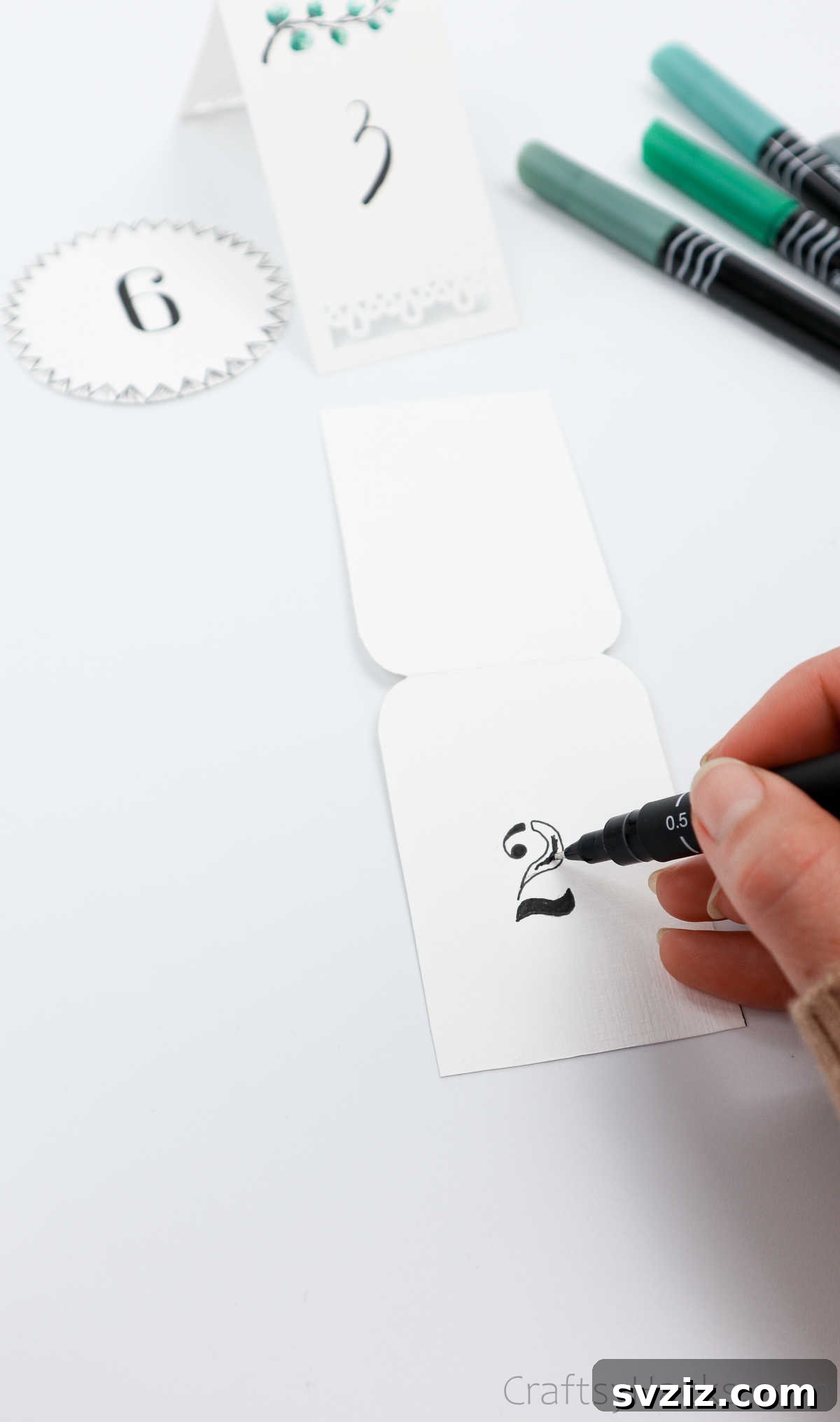 Stenciling a Table Number onto a Decorated Card