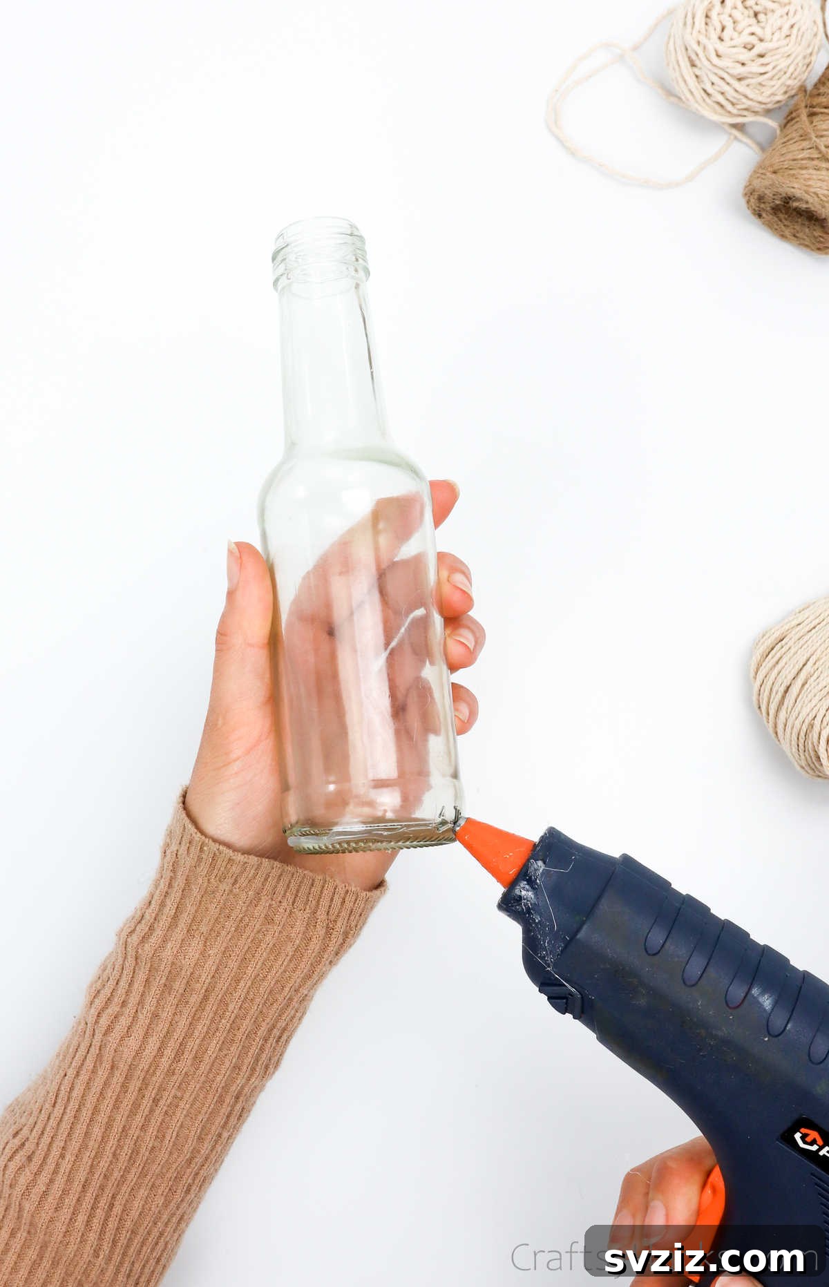 Applying Hot Glue to the Base of a Bottle