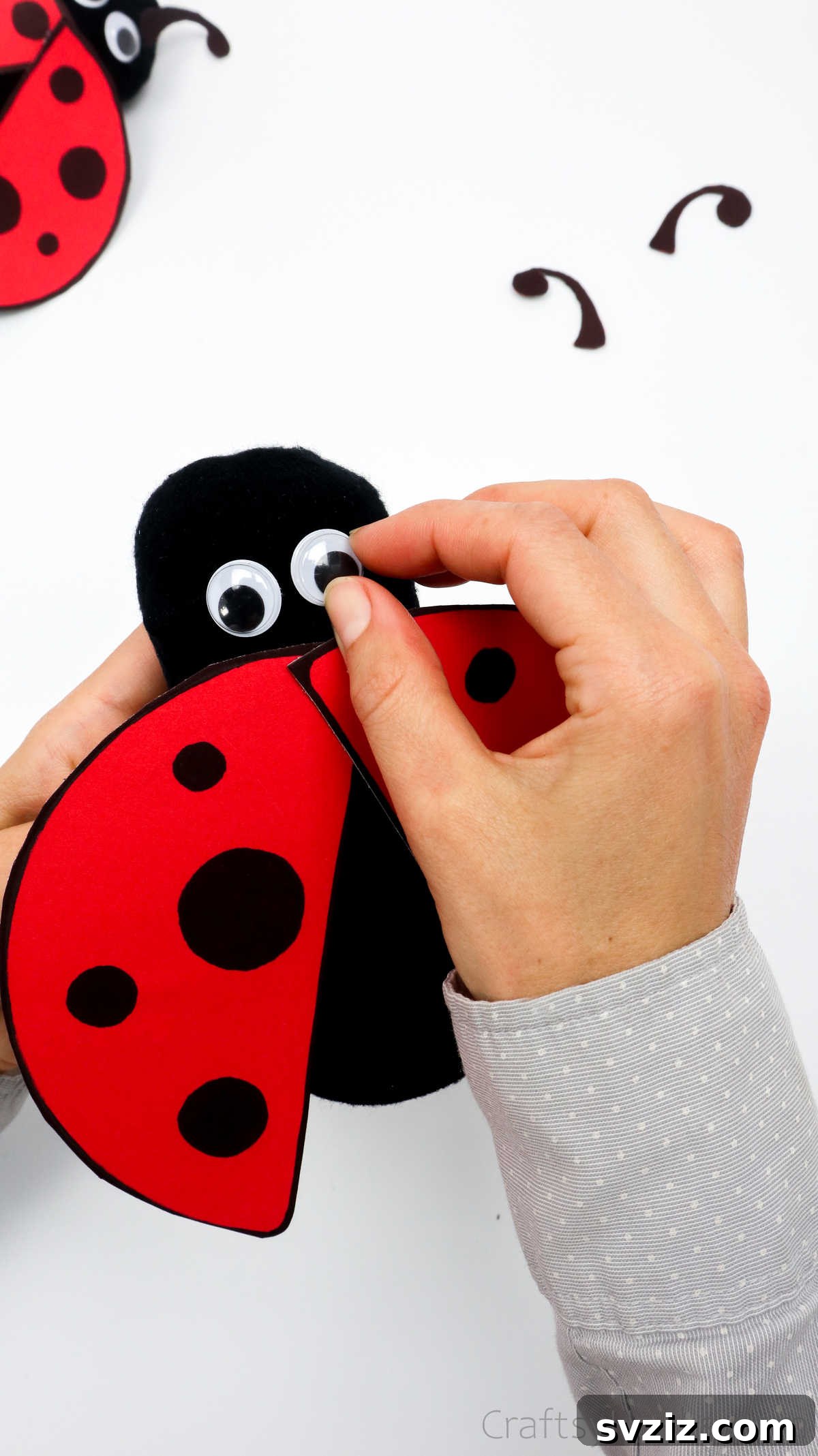 DIY Cardboard Tube Ladybugs 27 glueing eyes to ladybug