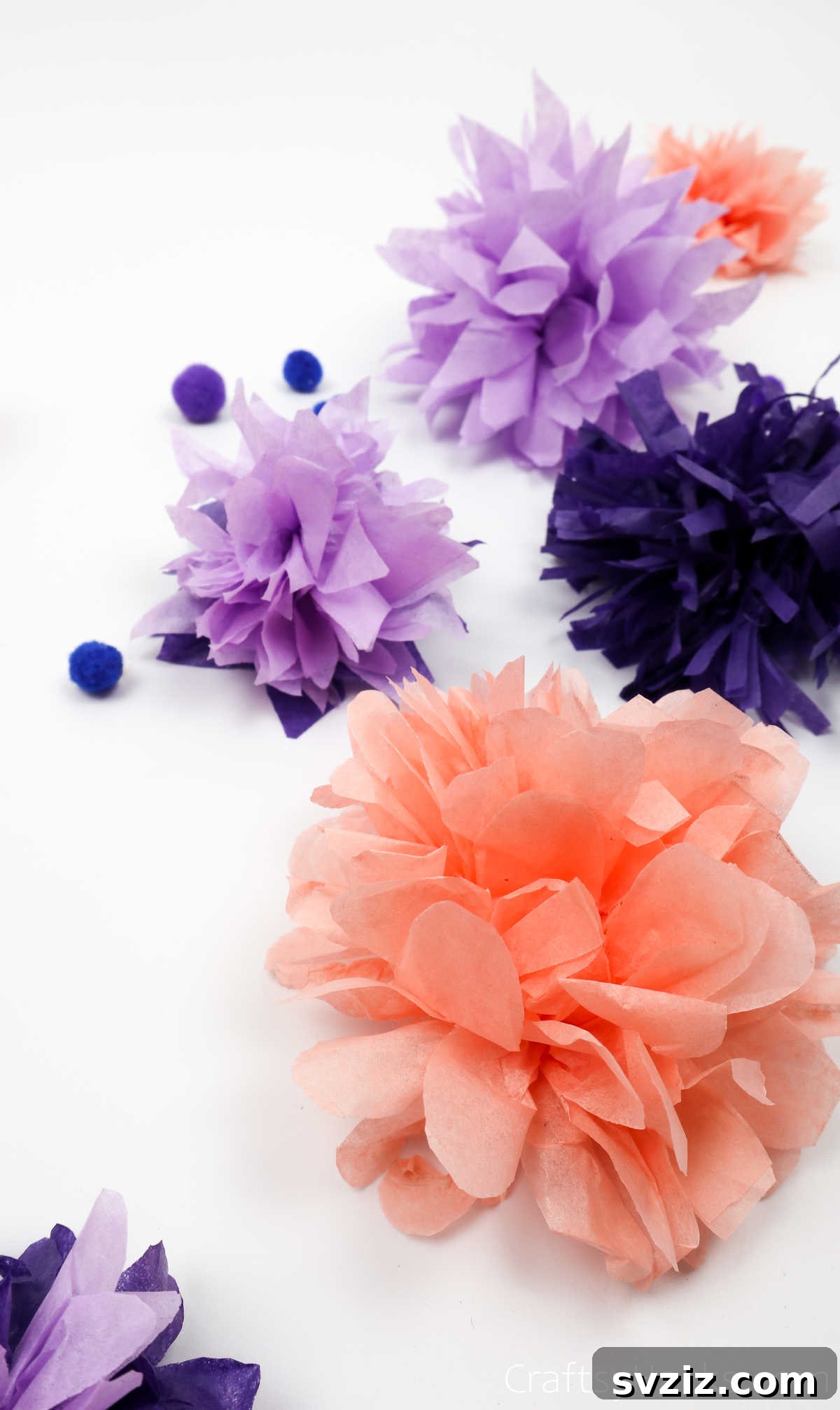 A collection of tissue paper flowers in varying sizes, illustrating how different sheet counts affect fullness