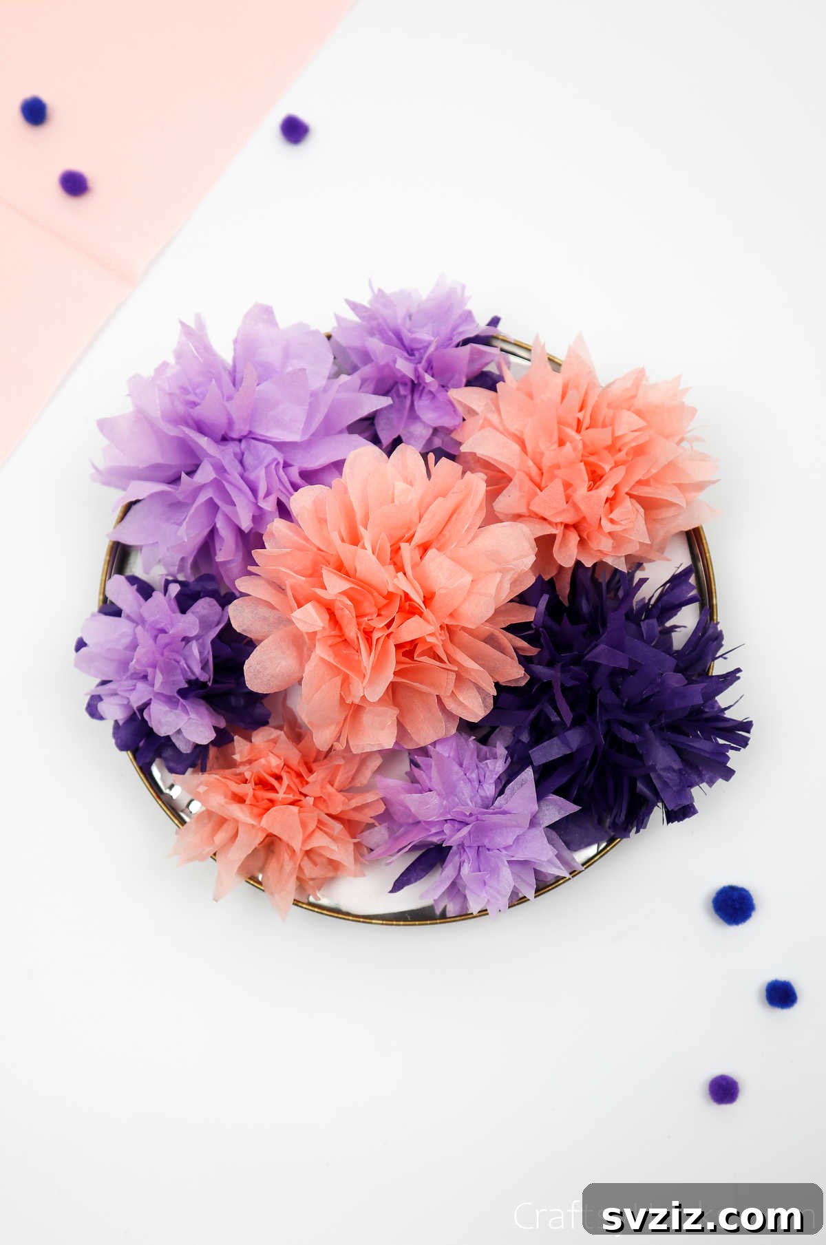 A charming collection of DIY tissue paper flowers in various colors and sizes, ideal for budget-friendly decorations