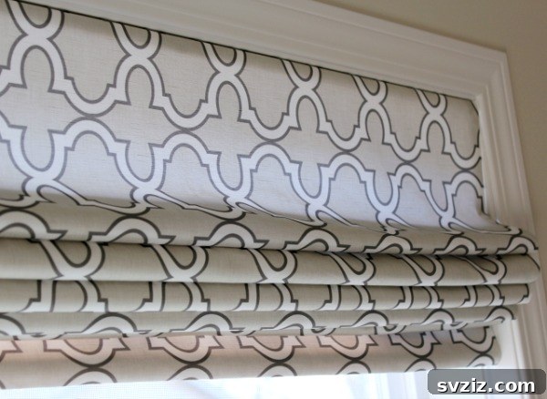 Effortless Stitching: 47 Projects for Every Skill Level 42 A custom DIY Roman shade in a neutral geometric pattern, neatly folded at the window.