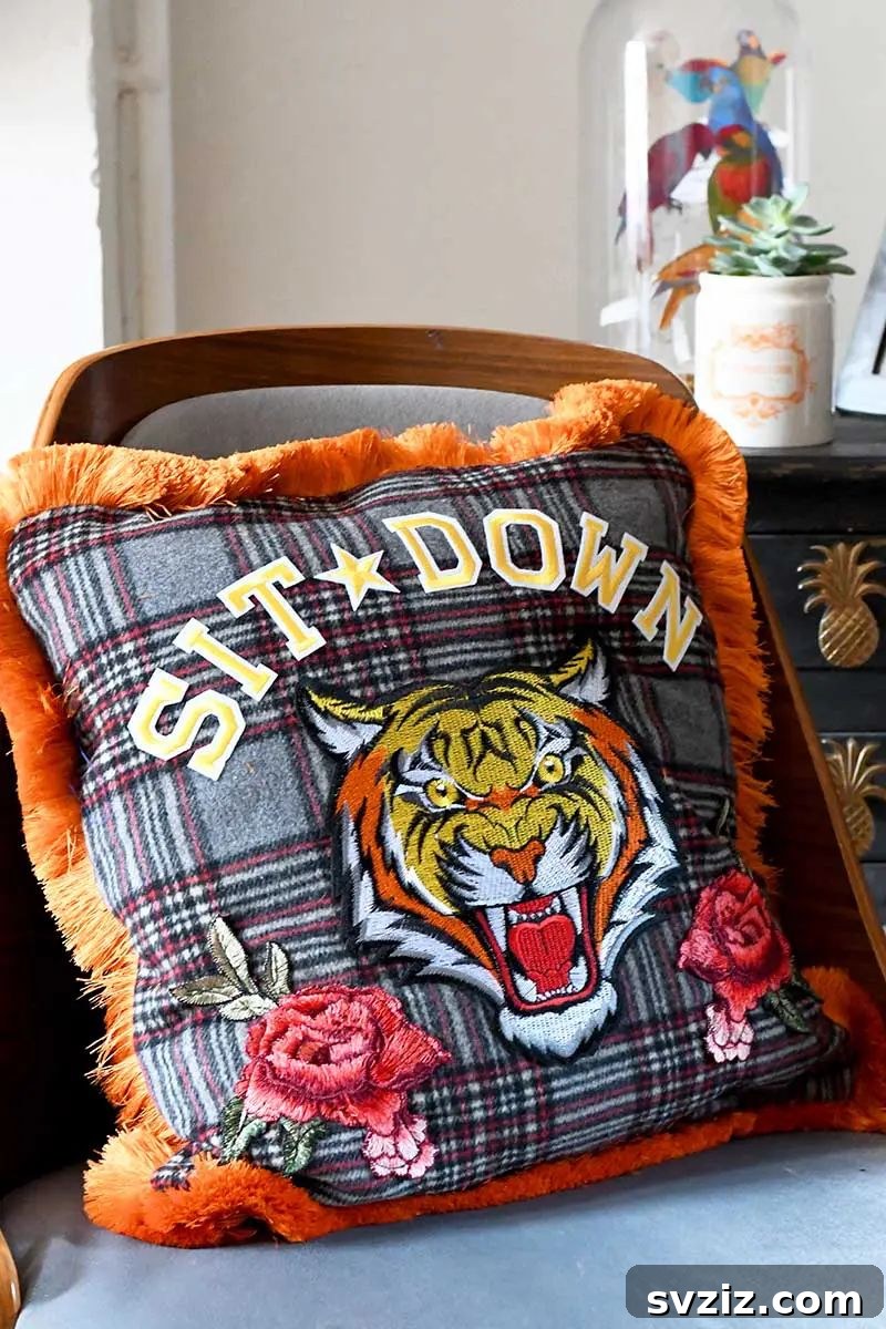 Effortless Stitching: 47 Projects for Every Skill Level 45 A stylish throw pillow featuring a large, embroidered tiger head design on a vibrant blue background.